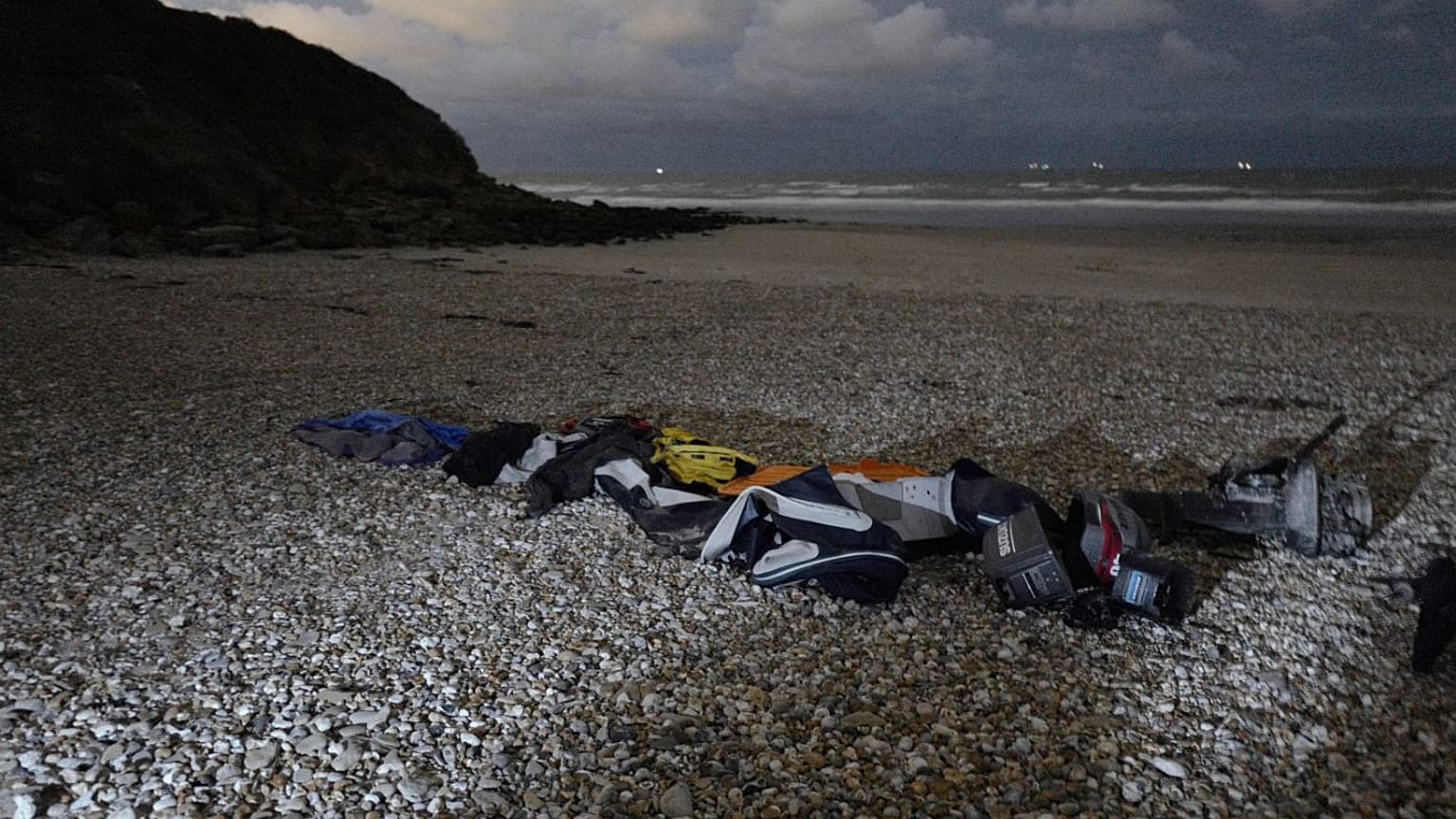 Life jackets and a damaged inflatable small boat on the shore in Wimereux, northern France.