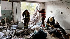 First responders work in a damaged residential building in Odesa, Ukraine, early Friday, July 1, 2022, following Russian missile attacks.