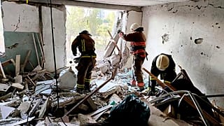 First responders work in a damaged residential building in Odesa, Ukraine, early Friday, July 1, 2022, following Russian missile attacks.