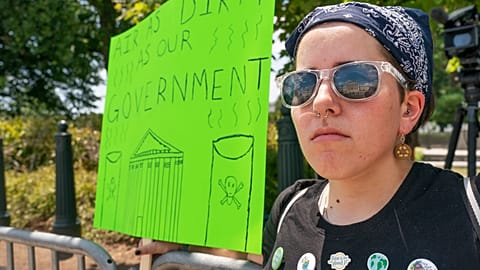 Erin Tinerella, of Chicago, who is in Washington for the summer at an internship, protests against climate change after the Supreme Court's EPA decision, June 30, 2022.