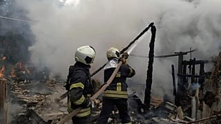Ukrainian firefighters work to extinguish a fire at damaged residential building in Lysychansk, Luhansk region, Ukraine, early Sunday, July 3, 2022.