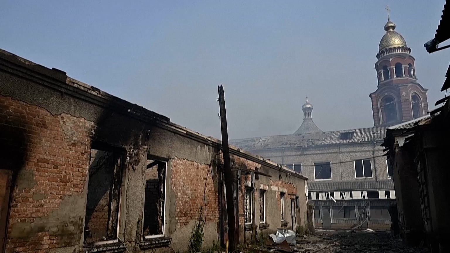 Destroyed buildings, with Orthodox church seen in background