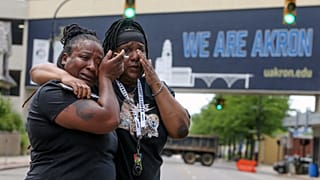 Sandra Dees, left, and Marquita Carter cry in front of the Harold K. Stubbs Justice Center, Sunday, July 3, 2022, in Akron, Ohio, after watching the bodycam footage