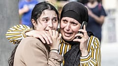 People react in front of the Field's shopping center in Copenhagen, Denmark Sunday, July 3, 2022.