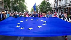 Demonstrators carry a giant EU flag during an anti-government rally near the Georgian Parliament in Tbilisi.