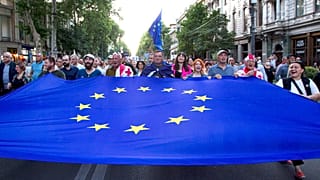 Demonstrators carry a giant EU flag during an anti-government rally near the Georgian Parliament in Tbilisi.