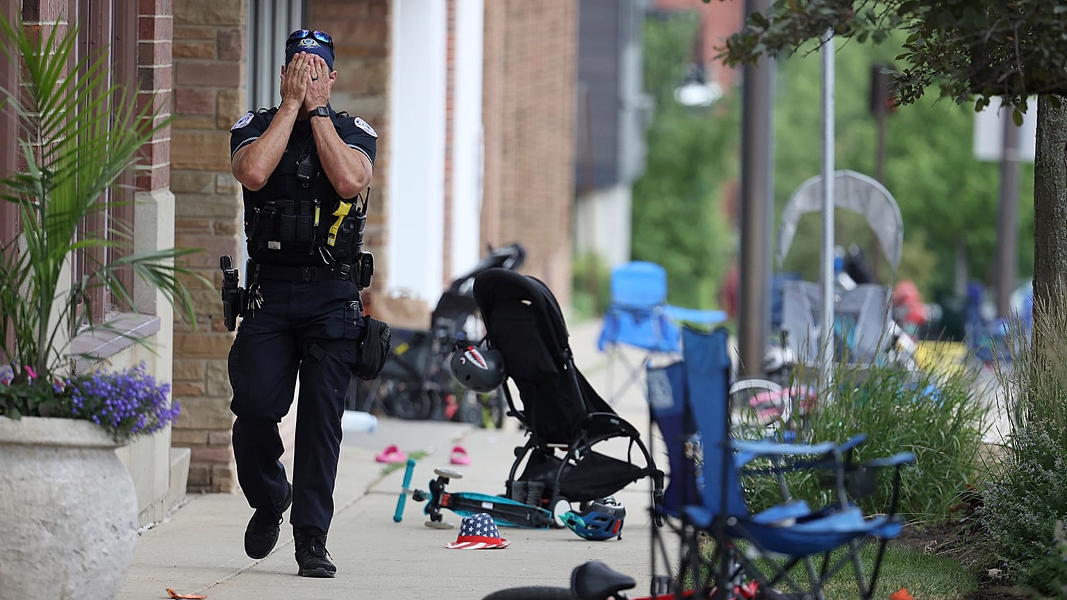 A Lake County police officer walks down Central Avenue in downtown Highland Park, a Chicago suburb, after a mass shooting at the 4 July parade