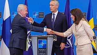 Finland's Foreign Minister Pekka Haavisto (L) Sweden's Foreign Minister Ann Linde (R) alongside NATO Secretary-General Jens Stoltenberg.