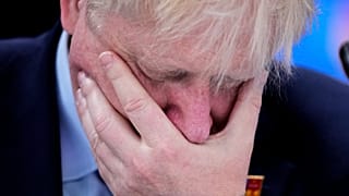 UK Prime Minister Boris Johnson with his hand over his face.