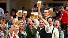 In this Saturday, Sept. 21, 2019 file photo, visitors lift glasses of beer during the opening of the 186th 'Oktoberfest' beer festival in Munich, Germany.