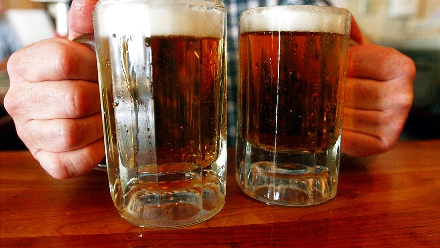 FILE - June 29, 2004 - a bartender serves two mugs of beer at a tavern in Montpelier