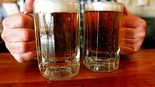 FILE - June 29, 2004 - a bartender serves two mugs of beer at a tavern in Montpelier