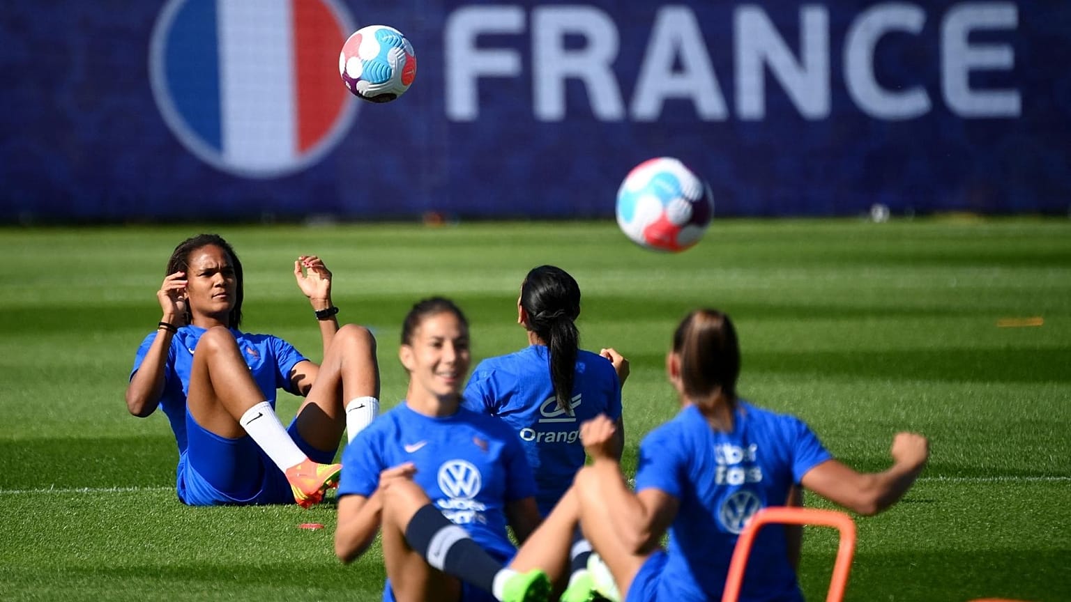 France's defender Wendie Renard (L) plays the ball during a training session at the team's base camp in Ashby-de-la-Zouch in central England, on July 5, 2022