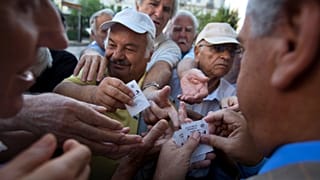 In this 2015 picture, pensioners wait outside the main gate of Greece's national bank to withdraw a maximum of 120 euros ($134) 