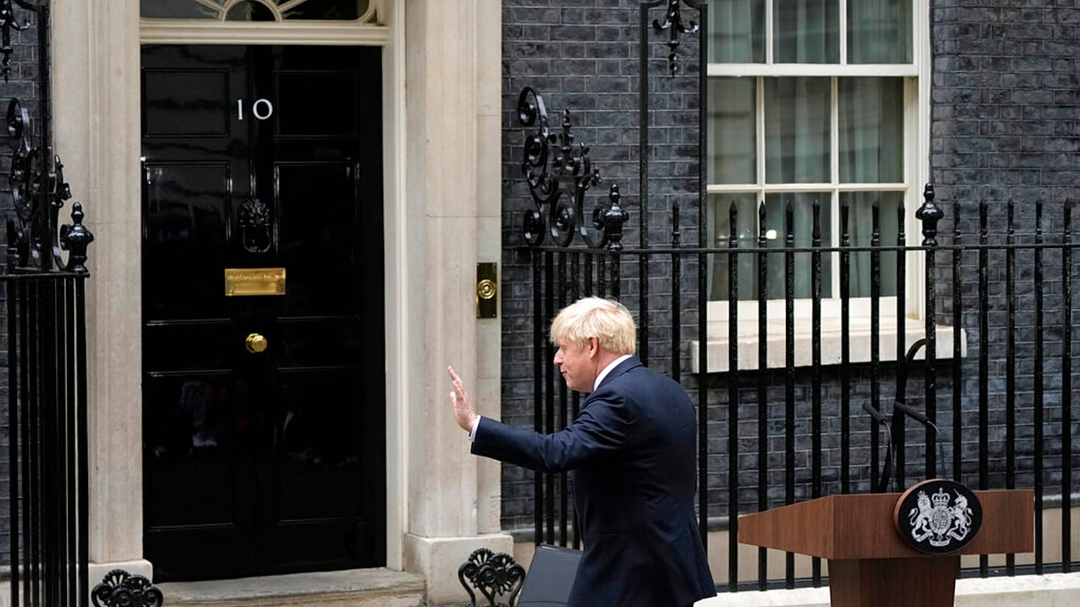 Prime Minister Boris Johnson waves after reading a statement outside 10 Downing Street
