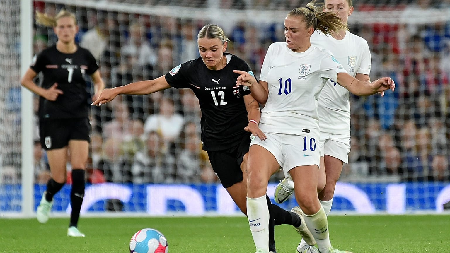 England's Georgia Stanway vies for the ball with Austria's Laura Wienroither, centre, during their Women Euro 2022 match in Manchester, England, July 6, 2022. 