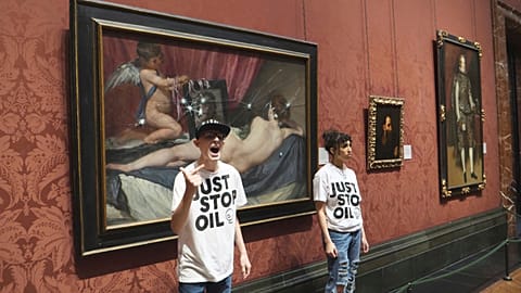 Just Stop Oil activists stand by a painting, after smashing the protective panel, at the National Portrait Gallery in London, 6 November 2023. 