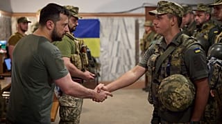 Ukrainian President Volodymyr Zelenskyy, left, awards a serviceman as he visits the war-hit Dnipropetrovsk region on 8 July 2022