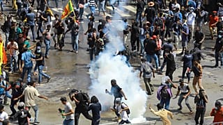 Police use tear gas to disperse the protesters in Colombo, Sri Lanka, Saturday, July 9, 2022. 