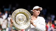 Kazakhstan's Elena Rybakina holds the trophy after winning the final of the women's tennis singles against Tunisia's Ons Jabeur at Wimbledon, July 9, 2022.