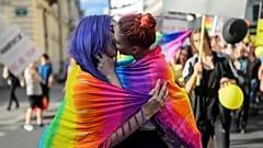 Women kiss as they take part in the Ljubljana Pride Parade in Ljubljana, on June 17, 2017.