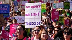 Demonstrators hold placards as they attend a march in support of the Abortion Rights group, in London.
