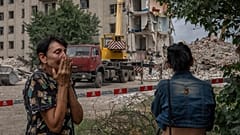 Iryna Shulimova, 59, weeps at the scene in the aftermath of a Russian rocket that hit an apartment residential block, in Chasiv Yar, eastern Ukraine, Sunday, 10 July 2022