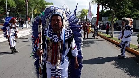 Dancers arrive at the church where mass will be held