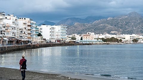 A woman walks on the beach of Ierapetra on the southeast coast of the Greek island of Crete.