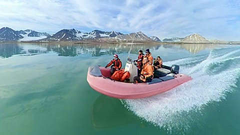 Researchers crossing a fjord in Ny-Ålesund, Svalbard
