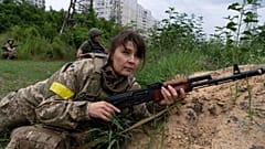 A woman holds a riffle as she attends a combat medic course training in Kyiv, Ukraine, Monday, July 11, 2022.