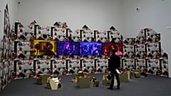 A man stands next to an installation part of the "Feeling Her Way" by artist Sonia Boyce, at the Great Britain's pavilion during the 59th Biennale of Arts exhibition in Venice