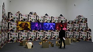 A man stands next to an installation part of the "Feeling Her Way" by artist Sonia Boyce, at the Great Britain's pavilion during the 59th Biennale of Arts exhibition in Venice