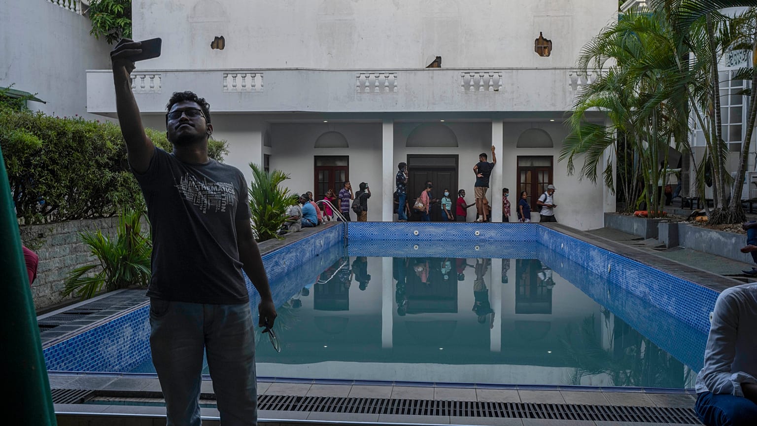 A man takes selfie at the swimmimg pool of the official residence of president Gotabaya Rajapaksa in Colombo, Sri Lanka.