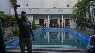 A man takes selfie at the swimmimg pool of the official residence of president Gotabaya Rajapaksa in Colombo, Sri Lanka.