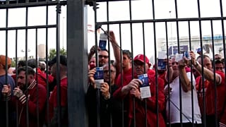 Liverpool fans wait in front of the of the Stade de France prior the Champions League final soccer match between Liverpool and Real Madrid in Paris, 28 May 2022