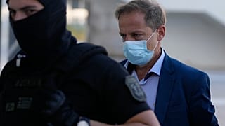 Dimitris Lignadis was accompanied by police as he arrived at the court in Athens on Wednesday.