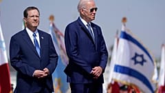 President Joe Biden stands with Israeli President Isaac Herzog, left, after arriving at Ben Gurion Airport, Wednesday, July 13, 2022, in Tel Aviv.