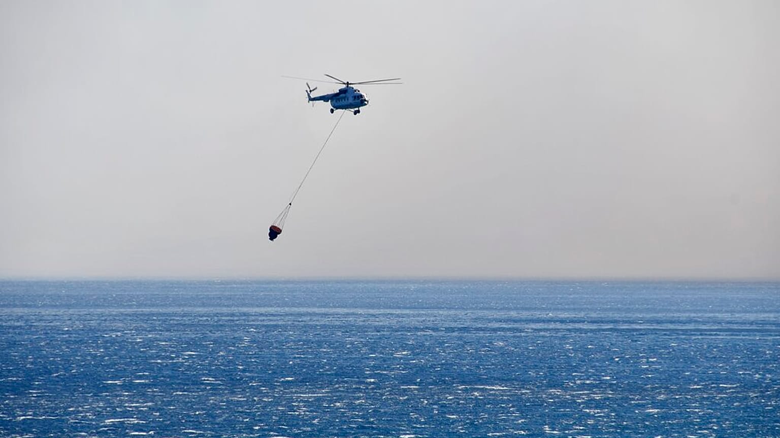A helicopter takes part in a search and rescue operation near the eastern Aegean Sea island of Samos, Greece,