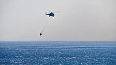 A helicopter takes part in a search and rescue operation near the eastern Aegean Sea island of Samos, Greece,