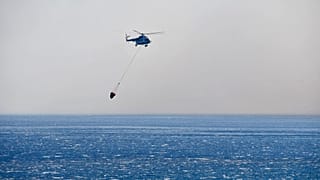 A helicopter takes part in a search and rescue operation near the eastern Aegean Sea island of Samos, Greece,