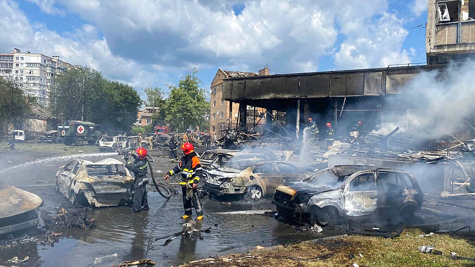 Ukrainian Emergency Service, firefighters work to extinguish fire at a building damaged by shelling, in Vinnytsia