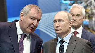 Russian President Vladimir Putin, right, listens to Roscosmos head Dmitry Rogozin, left, as he visits the Energomash rocket engine company in Luhansk, April 12, 2019.