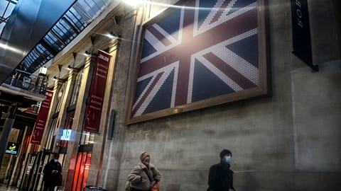 Passengers walk next to the Eurostar Terminal at Gare du Nord train station in Paris, Monday Dec. 21, 2020, next to a Eurostar train.