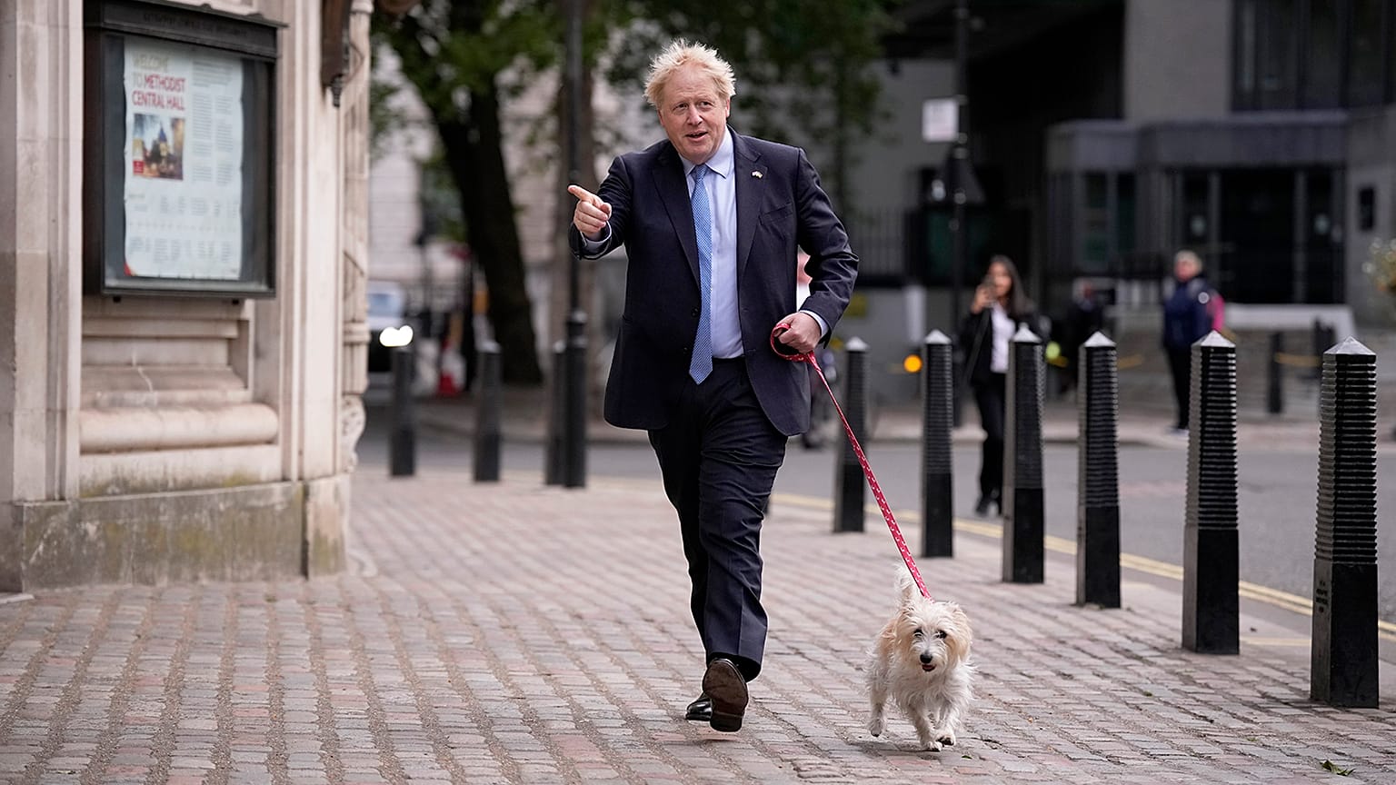 Britain's Prime Minister Boris Johnson arrives with his dog Dilyn to vote at a polling station in London on 5 May 2022