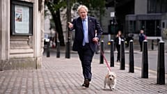 Britain's Prime Minister Boris Johnson arrives with his dog Dilyn to vote at a polling station in London on 5 May 2022