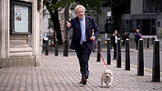 Britain's Prime Minister Boris Johnson arrives with his dog Dilyn to vote at a polling station in London on 5 May 2022