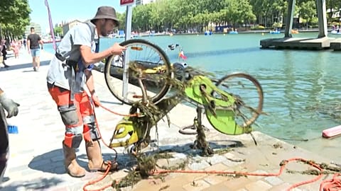 Workers clean up Paris canal.