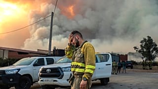 Egy tűzoltó sír egy erdőtűz közelében az északnyugat-spanyolországi Losacio térségében 2022\. július 17-én, vasárnap.