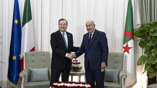 Italian Prime Minster Mario Draghi (L) shakes hands with Algerian President Abdelmadjid Tebboune (R) during their meeting in the capital Algiers on April 11 2022